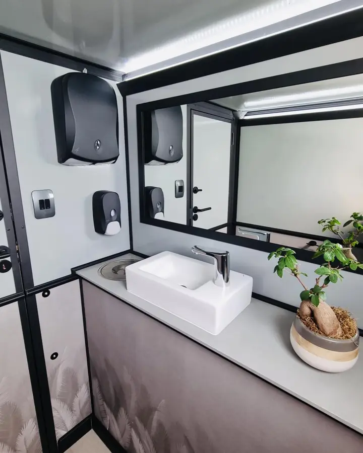 Trailer vanity with vessel sink, mirror, soap and towel dispensers