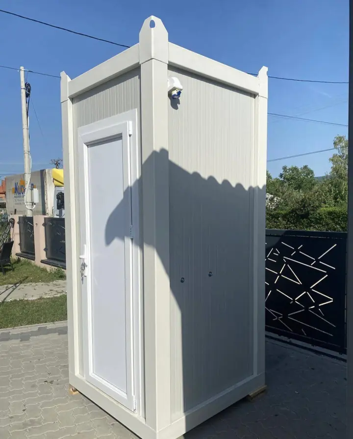 White single-stall portable restroom cabin with a residential-style door